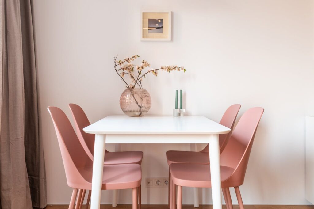 Dining table and pink chairs in light dining room